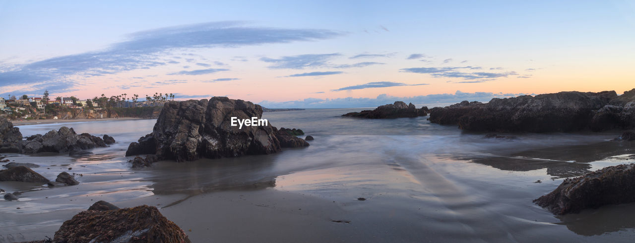 Scenic view of sea against cloudy sky