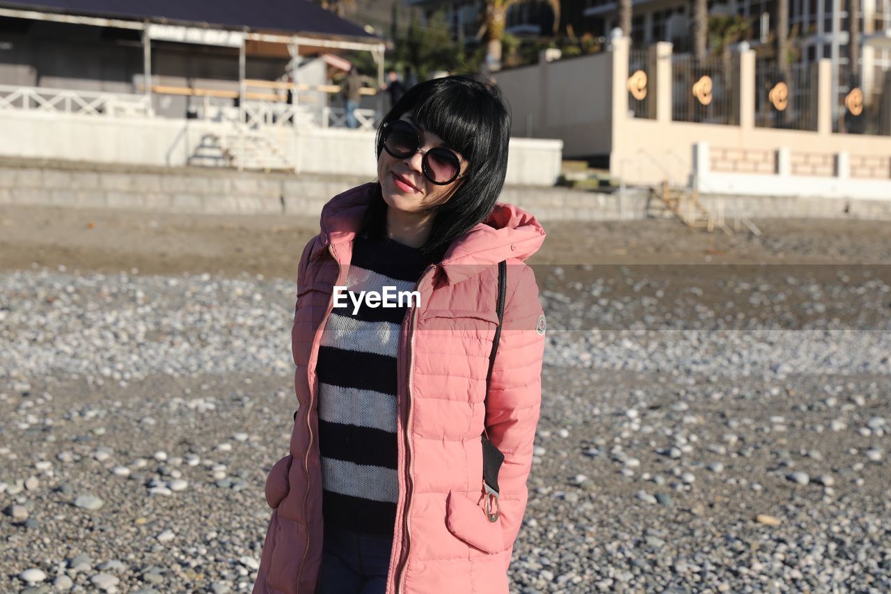 Portrait of woman standing at beach