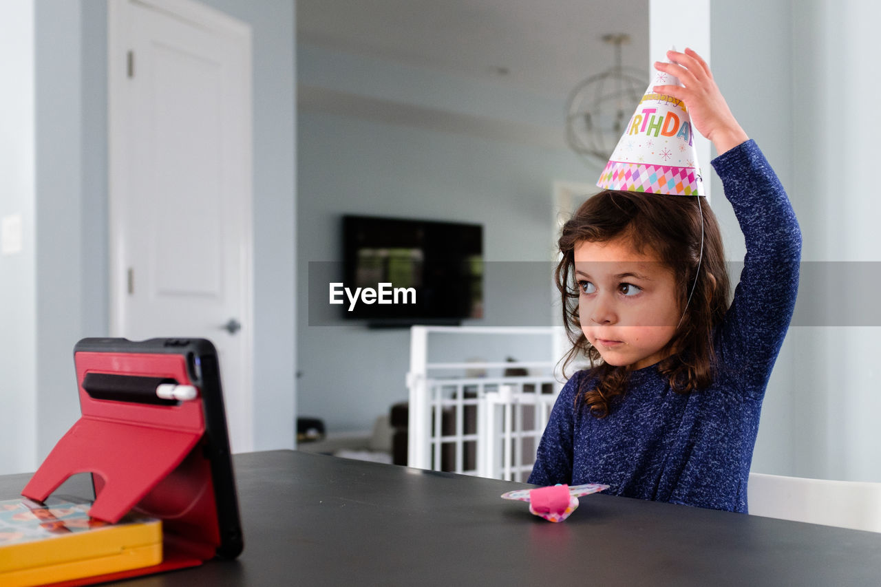 Little girl celebrating a birthday over zoom