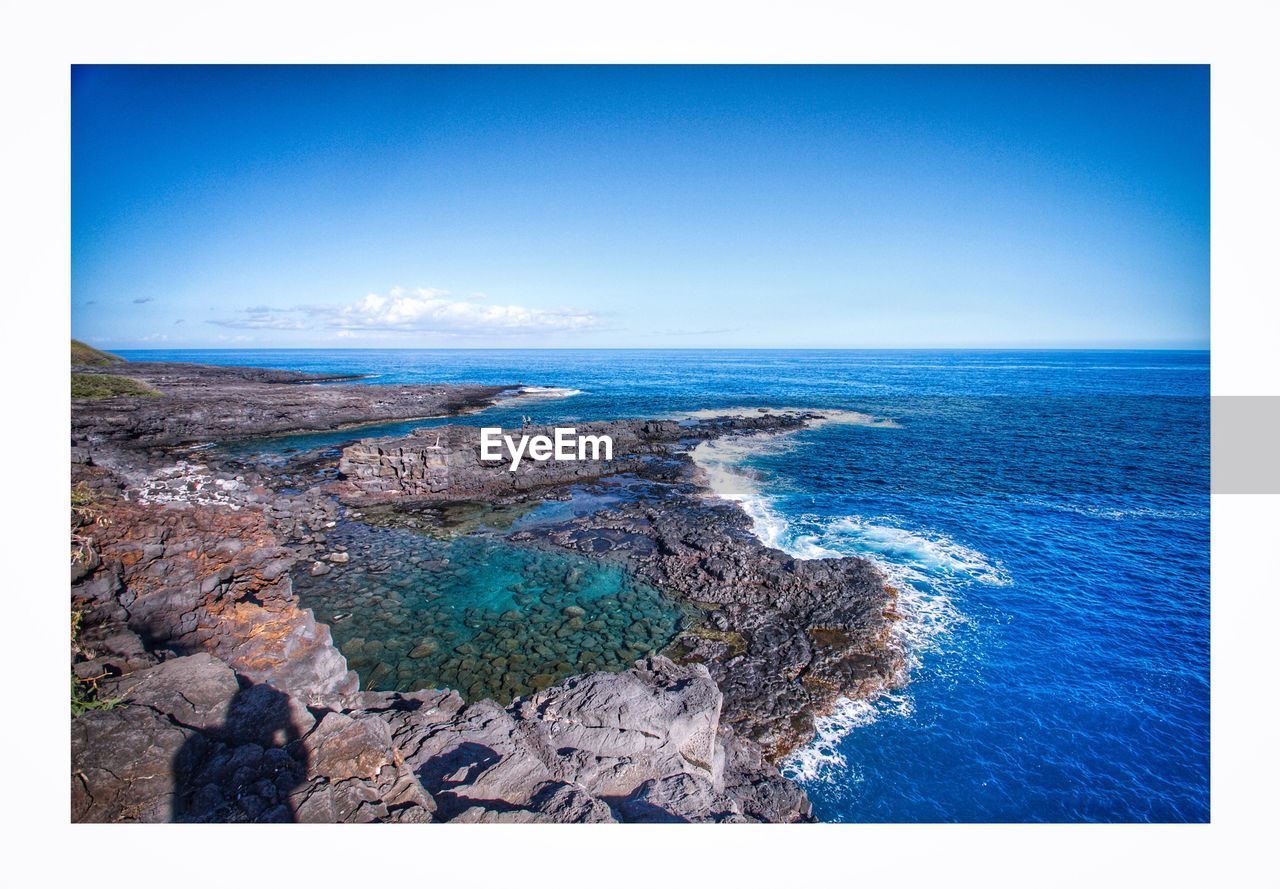 Scenic view of sea against clear blue sky