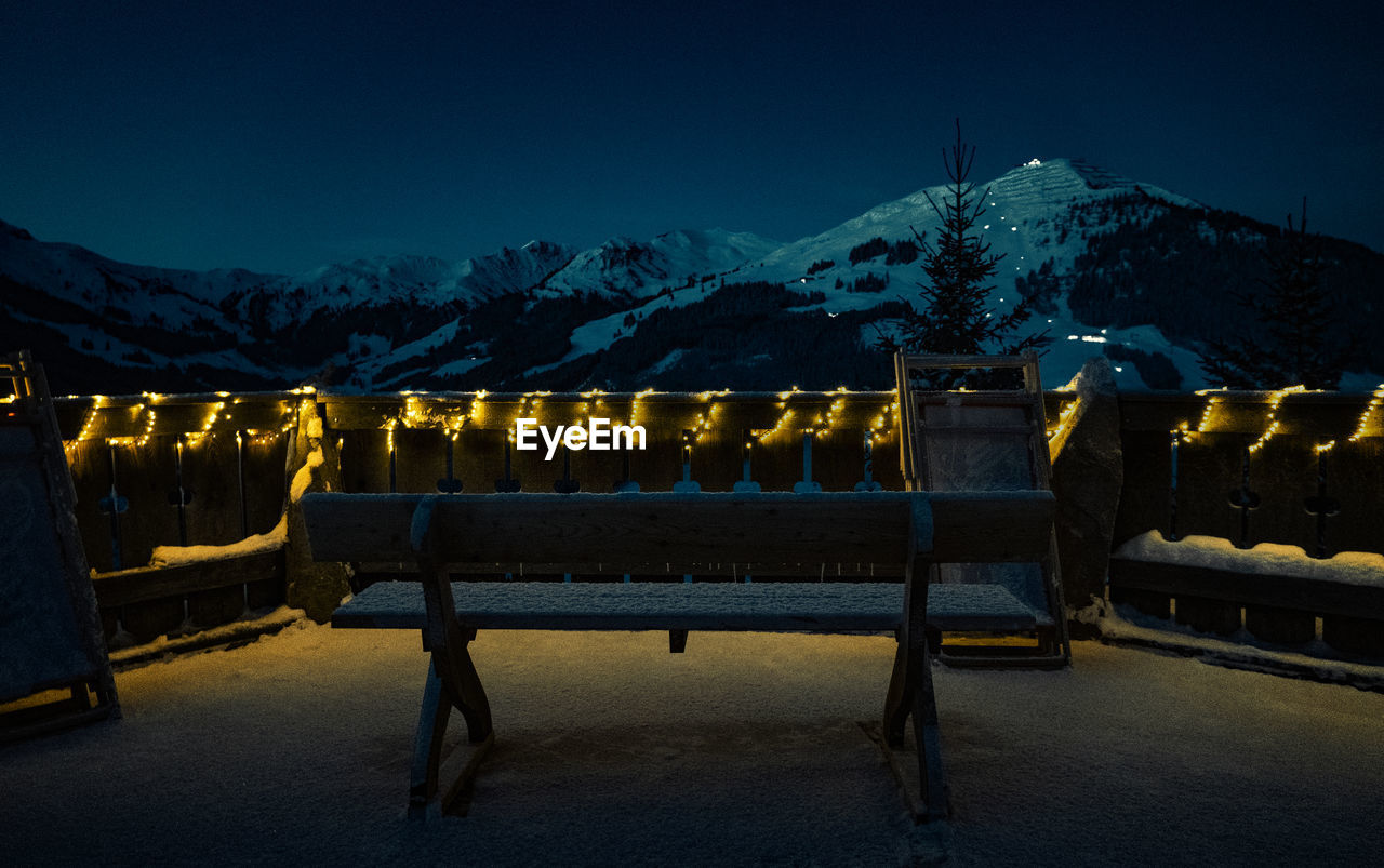 night, evening, mountain, snow, darkness, illuminated, cold temperature, dusk, winter, sky, mountain range, nature, light, architecture, scenics - nature, no people, travel destinations, beauty in nature, snowcapped mountain, environment, landscape, reflection, screenshot, travel, seat, outdoors