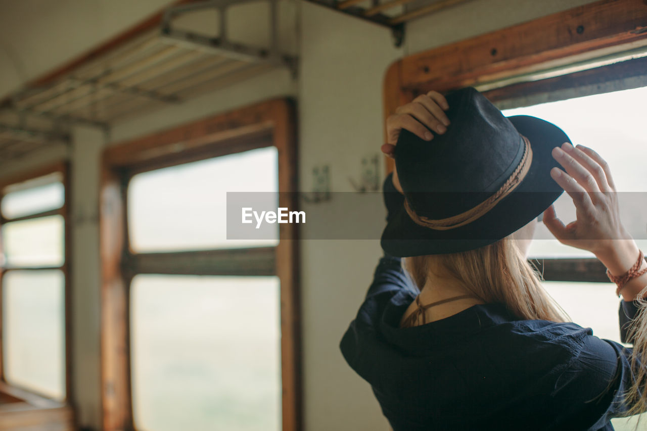 Woman wearing hat in train