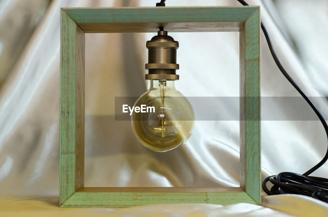 HIGH ANGLE VIEW OF ILLUMINATED LIGHT BULB