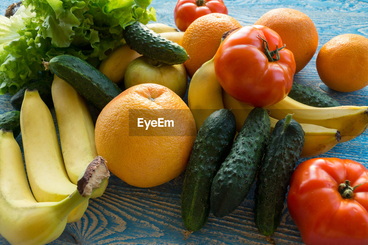 HIGH ANGLE VIEW OF FRUITS AND VEGETABLES ON ORANGE