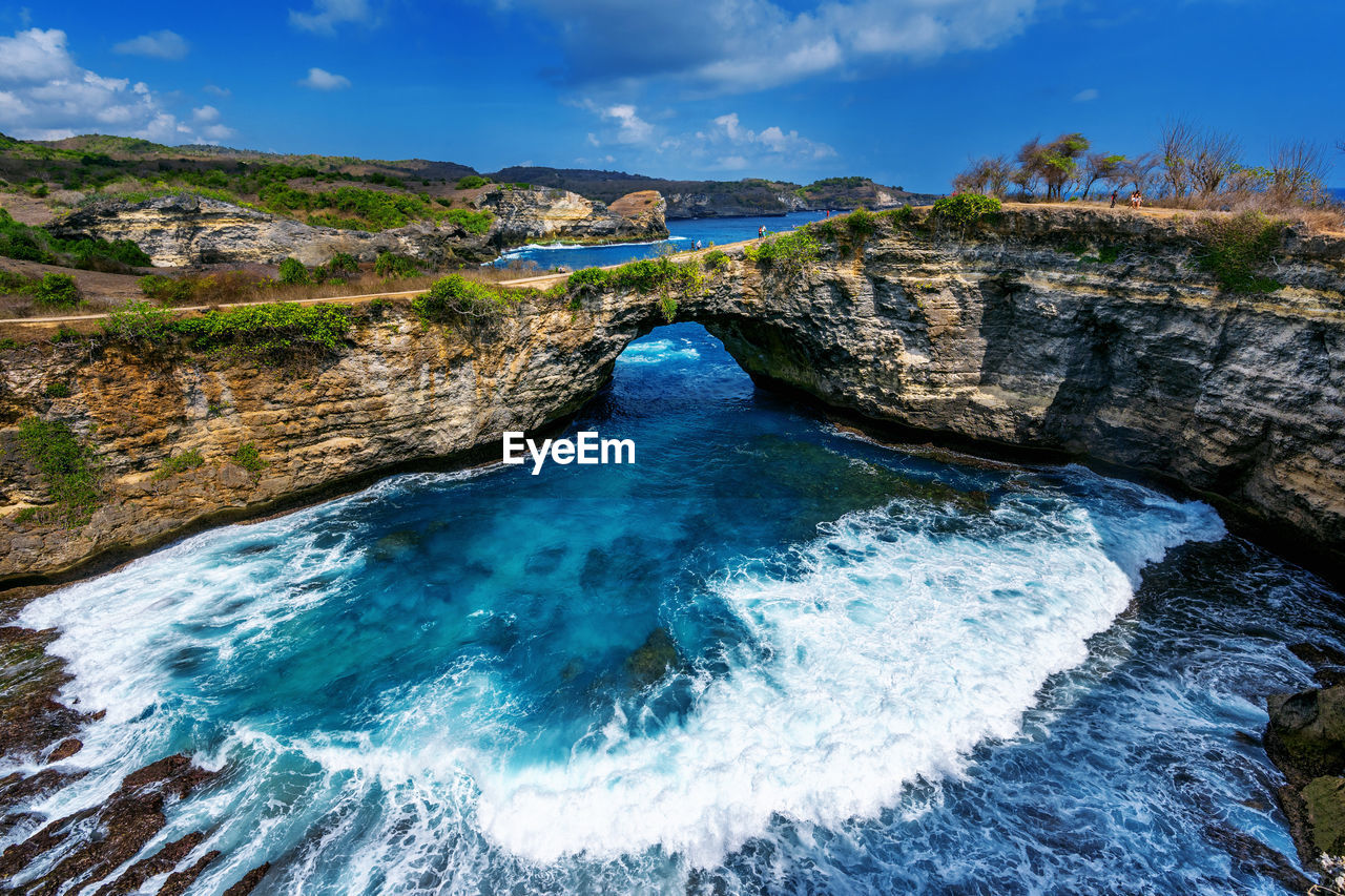 SCENIC VIEW OF SEA AGAINST ROCK FORMATION