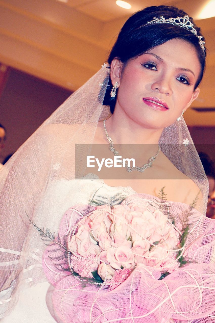 Portrait of bride with bouquet during wedding ceremony