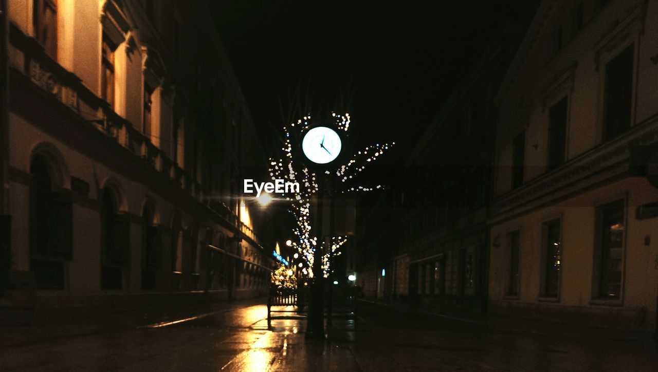 VIEW OF ILLUMINATED STREET LIGHTS AT NIGHT