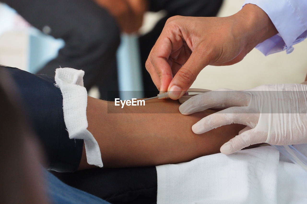 Close-up of doctor taking blood sample of patient 