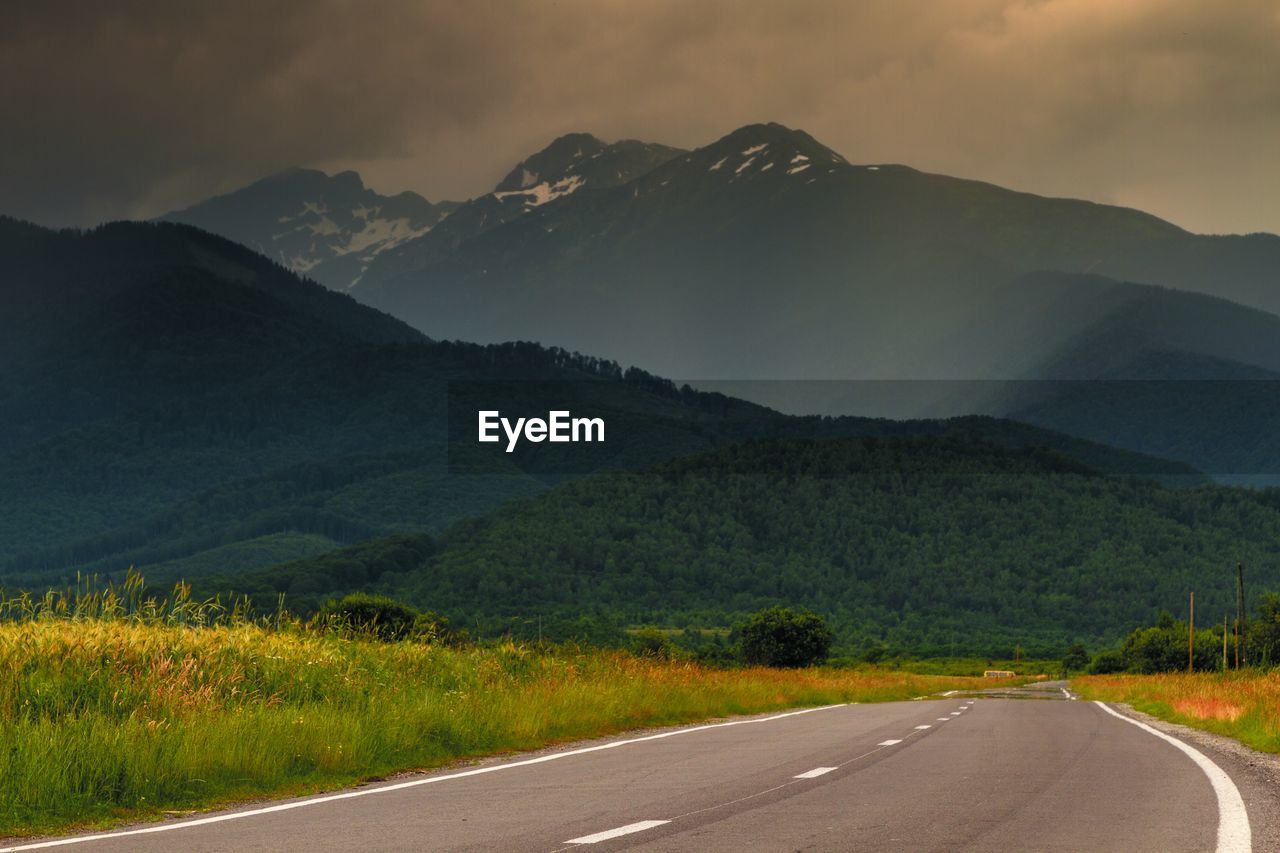 Mountain Road Sky Transportation Scenics - Nature Beauty In Nature Tranquil Scene Mountain Range Cloud - Sky Tranquility Landscape The Way Forward No People Non-urban Scene Direction Nature Sign Environment Plant Symbol Outdoors Dividing Line View From Your Car