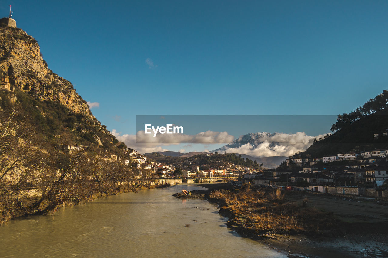 Scenic view of sea and mountains against sky