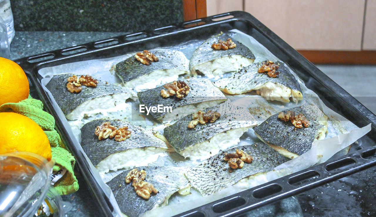 High angle view of fish in tray on marble
