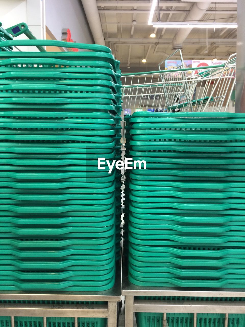 Stack of shopping baskets at supermarket