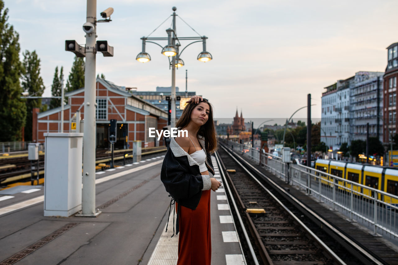 Side view of woman on railroad station platform