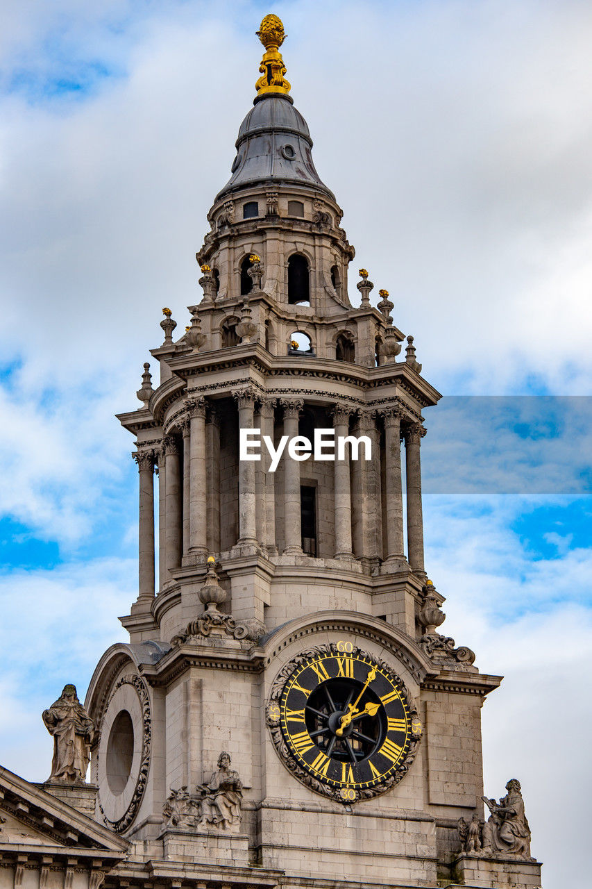 Low angle view of clock tower against sky