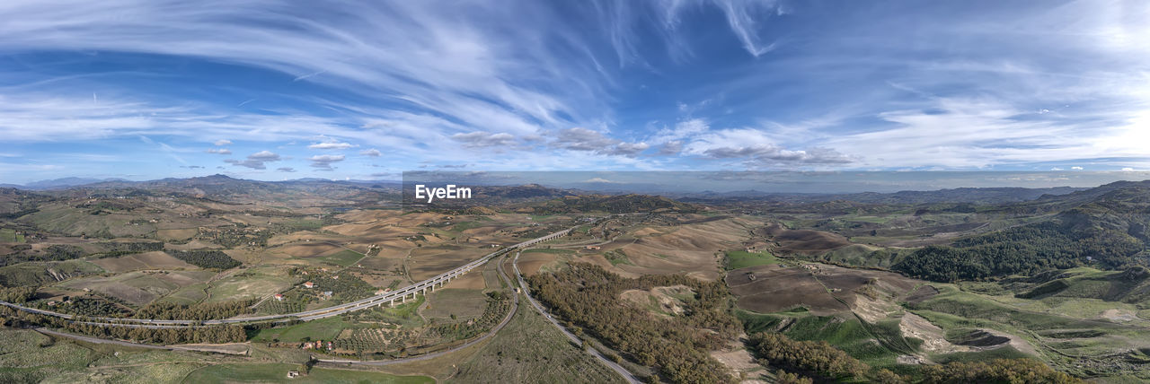 Stunning panoramic views of the landscape with highway to the mountains. volcano etna in the center