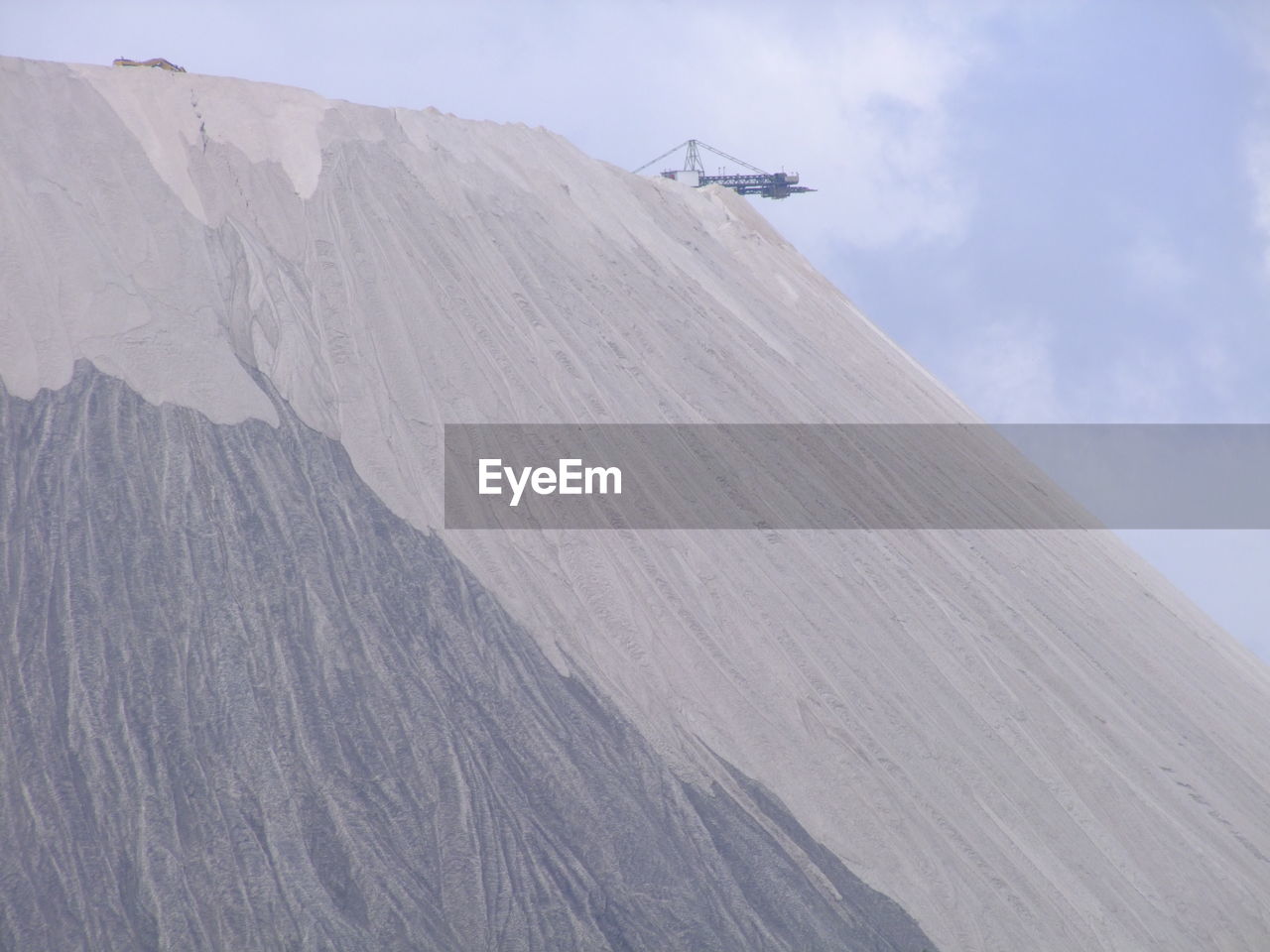 LOW ANGLE VIEW OF MOUNTAIN AGAINST SKY DURING WINTER