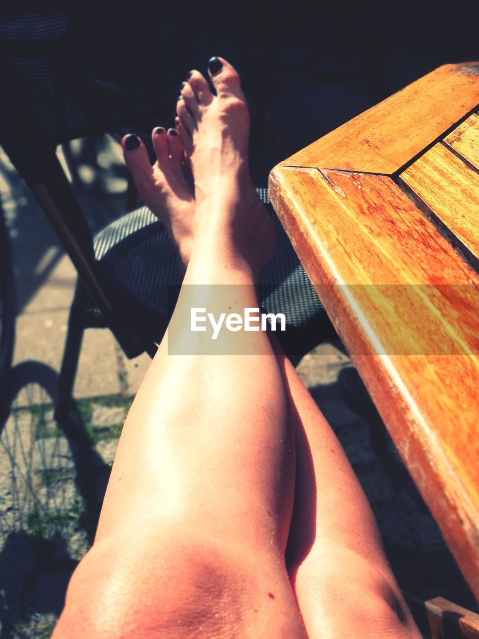 LOW SECTION OF PERSON LYING DOWN ON FLOOR