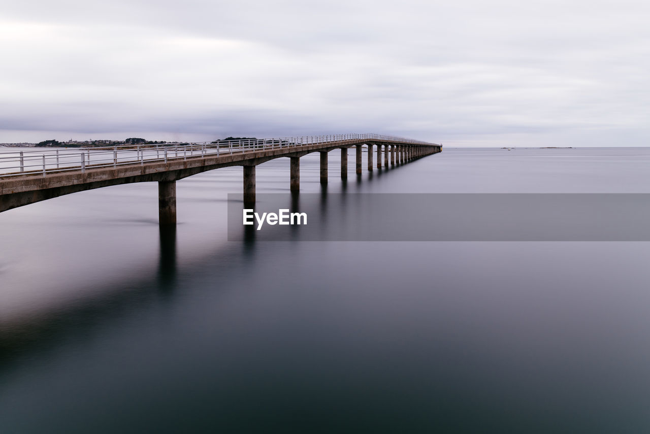 Jetty to ferry to ile de batz in the harbour of roscoff, brittany. view at sunset