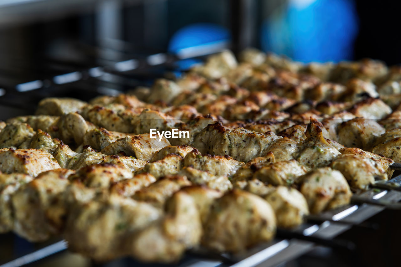 Cooking chicken tikka, traditional indian and pakistani dish cooked on charcoal and flame.