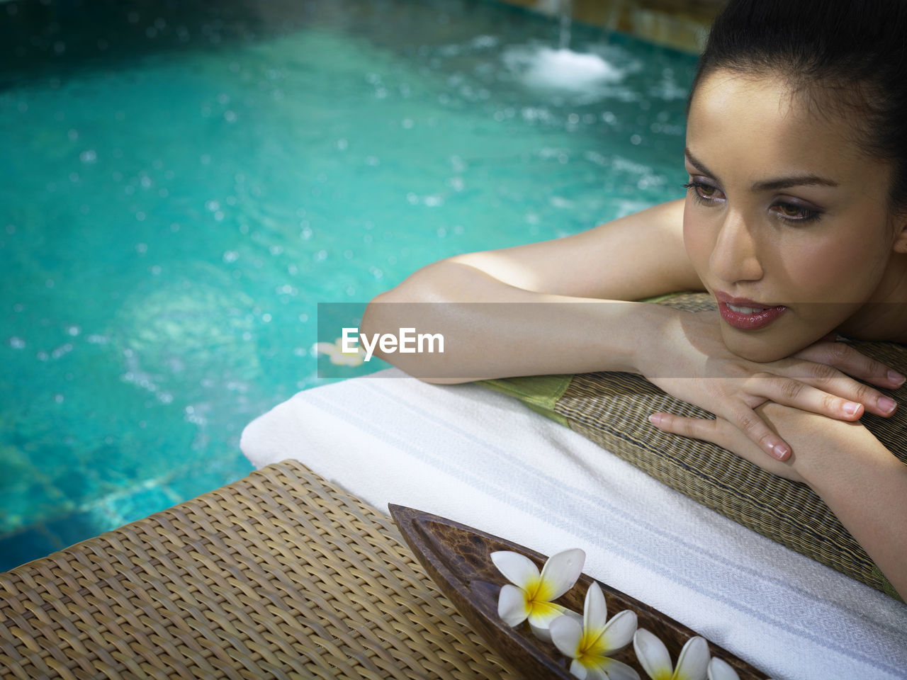 Young woman relaxing at poolside