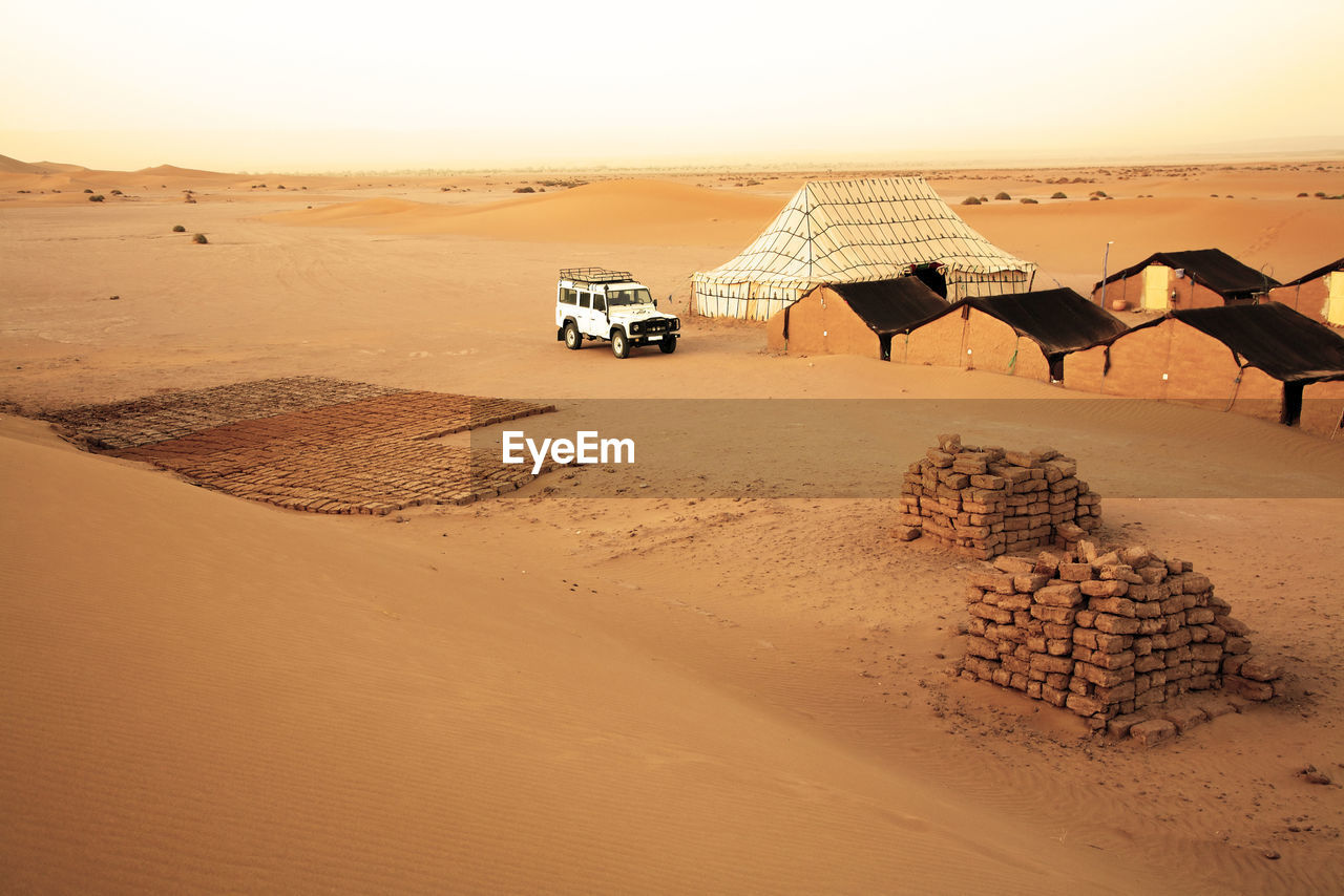 Scenic view of mud huts in the desert