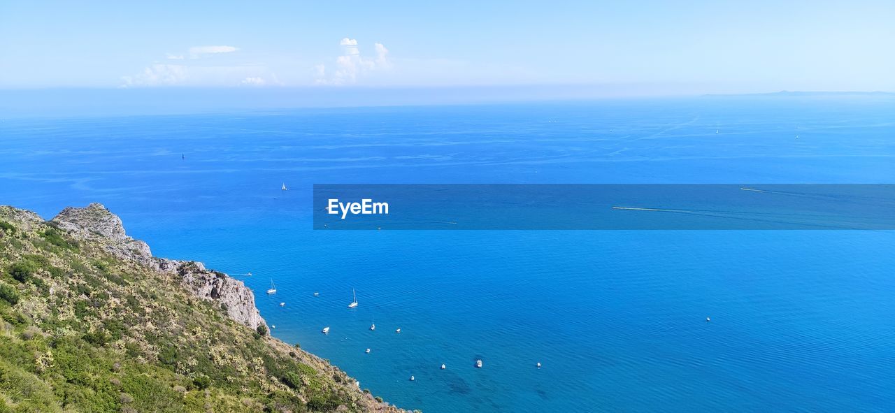 sea, water, scenics - nature, beauty in nature, sky, coast, land, horizon, horizon over water, nature, cliff, beach, blue, tranquil scene, tranquility, ocean, body of water, day, no people, terrain, coastline, high angle view, idyllic, travel, environment, travel destinations, outdoors, shore, non-urban scene, landscape, cloud, seascape, bay, islet, mountain, tourism, rock, promontory, vacation, island, aerial view, plant