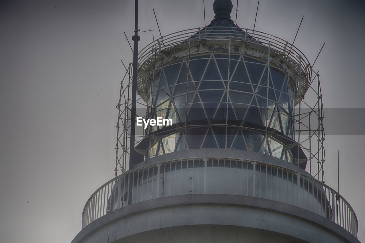 LOW ANGLE VIEW OF WATER TOWER ON SILHOUETTE OF LIGHTHOUSE