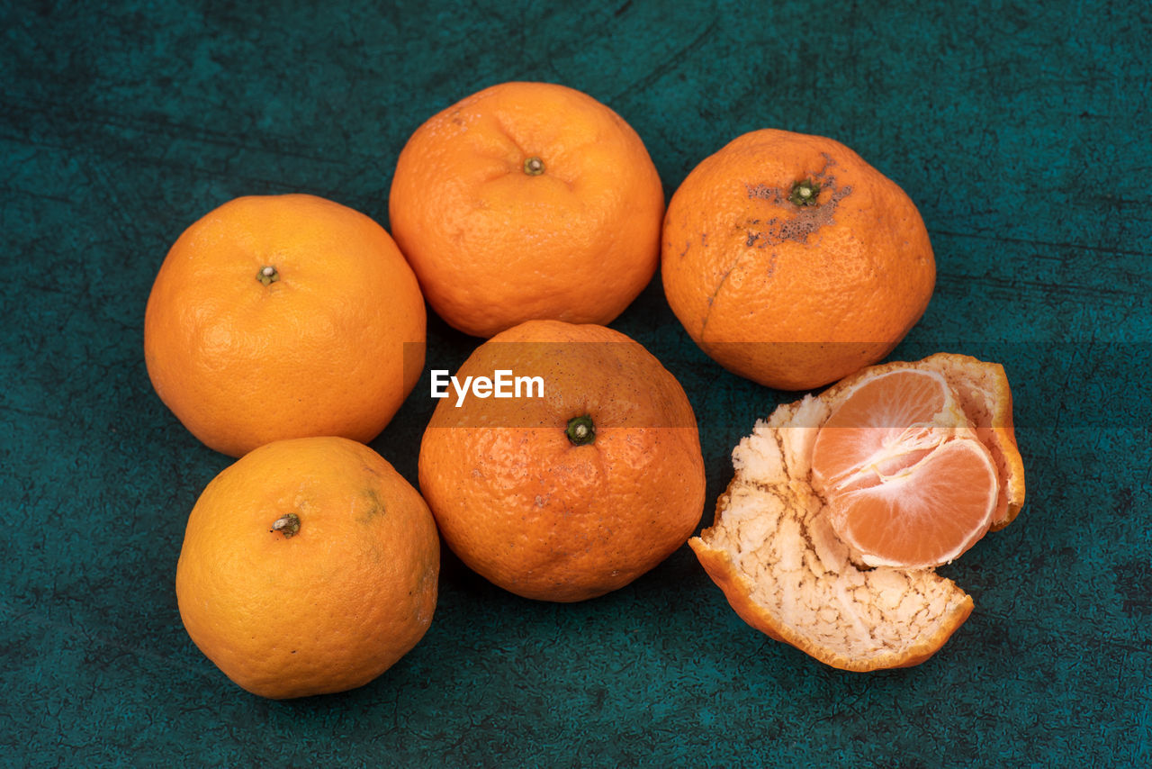 food and drink, food, healthy eating, fruit, freshness, orange color, wellbeing, produce, tangerine, clementine, citrus fruit, plant, orange, citrus, no people, high angle view, studio shot, calamondin, still life, indoors, blood orange, group of objects, close-up, grapefruit, large group of objects, colored background, organic