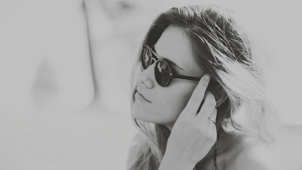 Close-up of woman in sunglasses at home