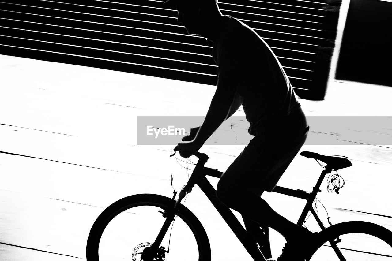 Man riding bicycle in building