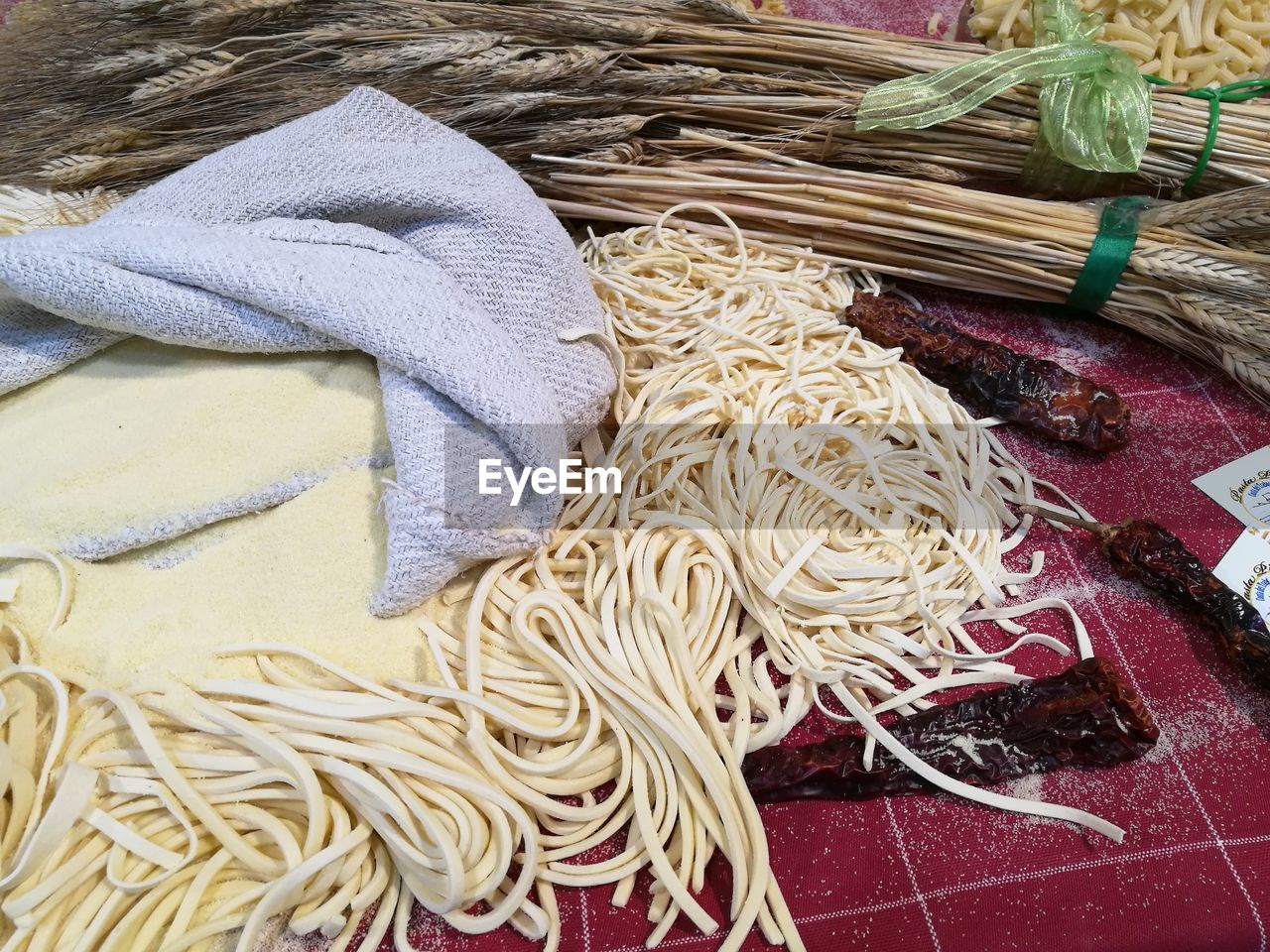 High angle view of pasta and dried chili peppers on table