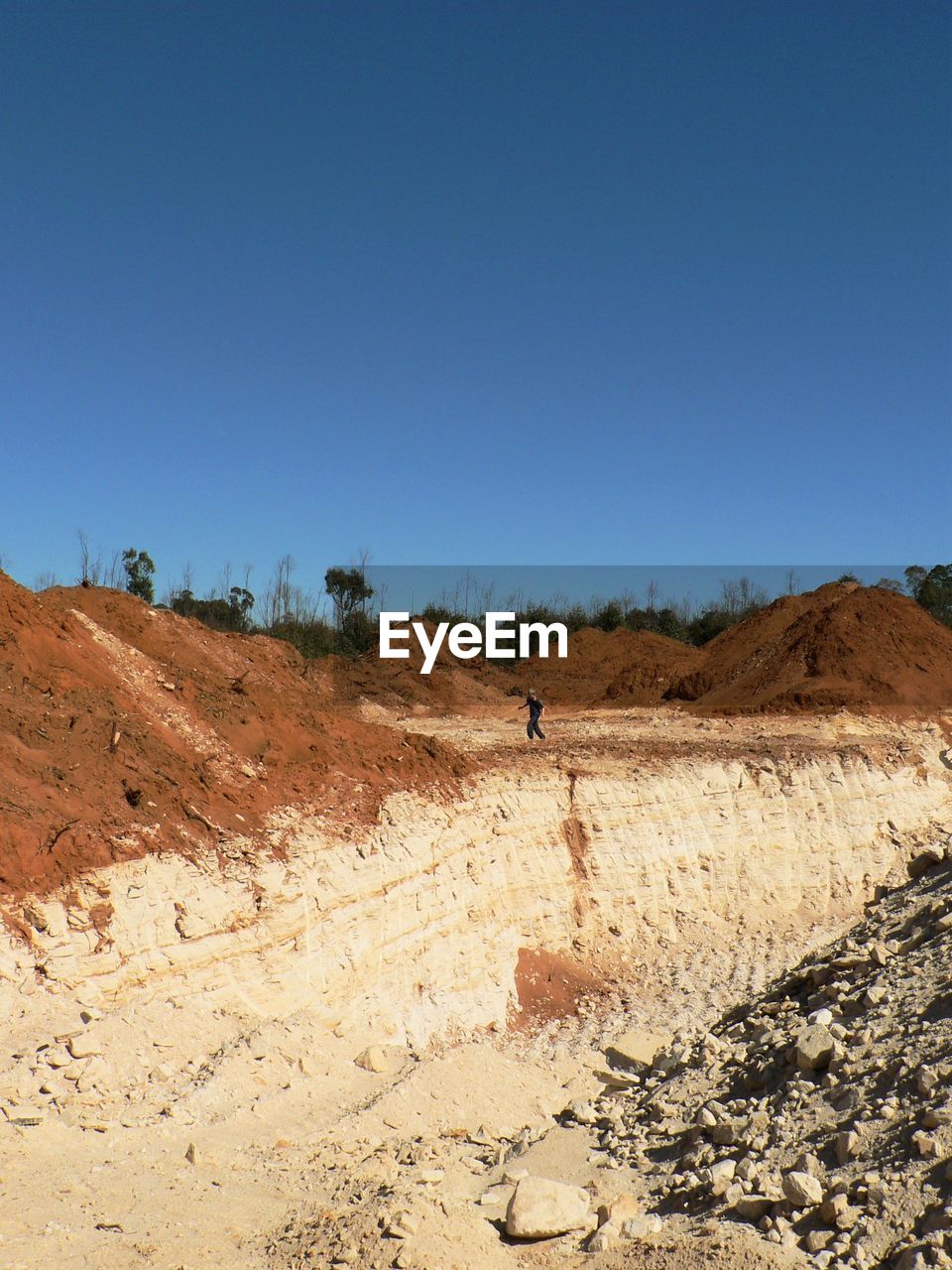 Scenic view of quarry against clear blue sky