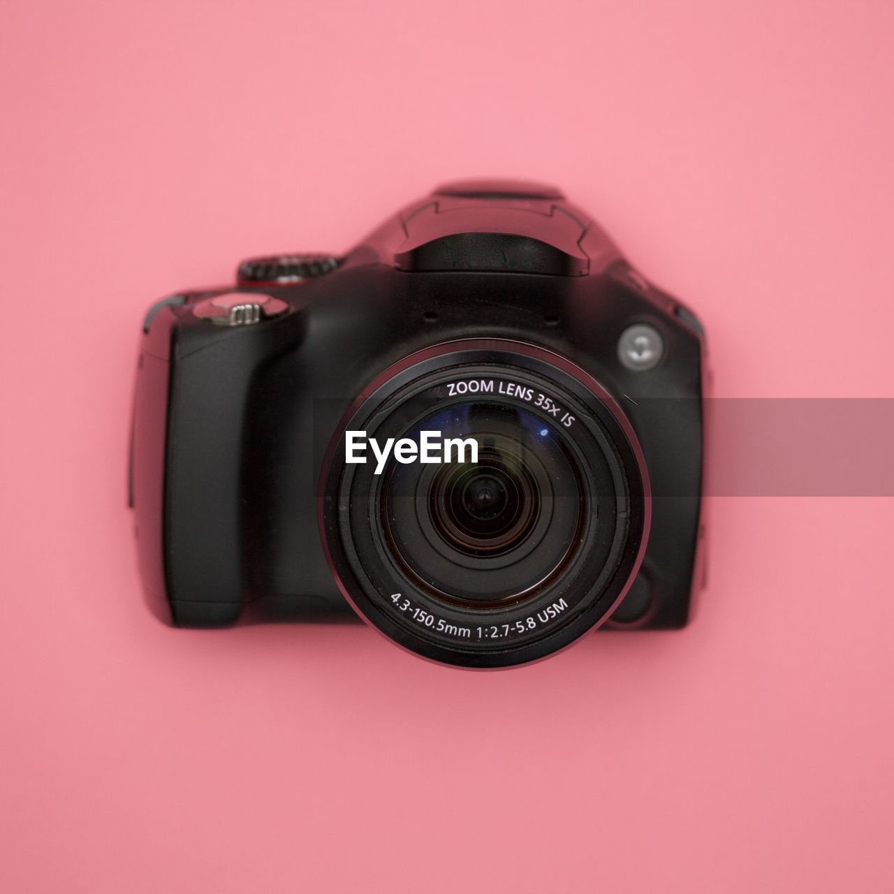Close-up of camera on pink background