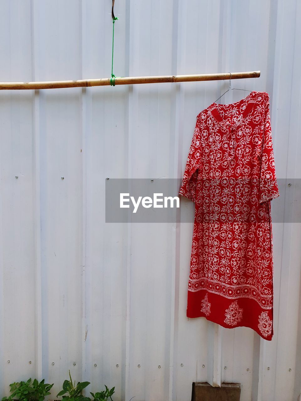 Close-up of clothes drying against white wall