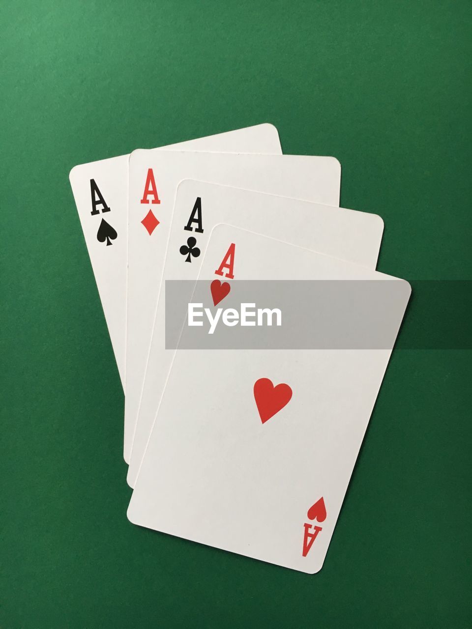 High angle view of aces cards on green table