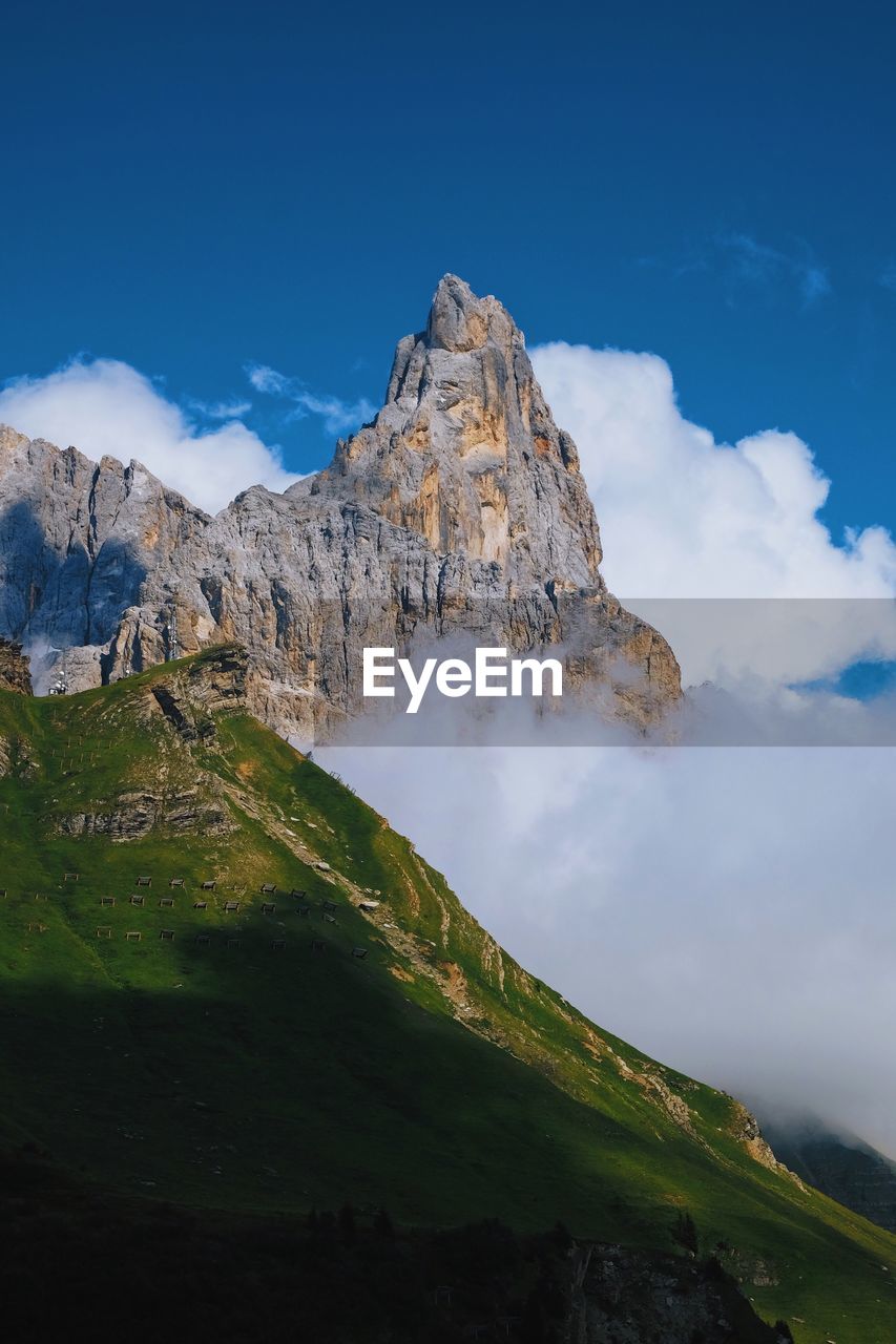 Scenic view of mountain against blue sky