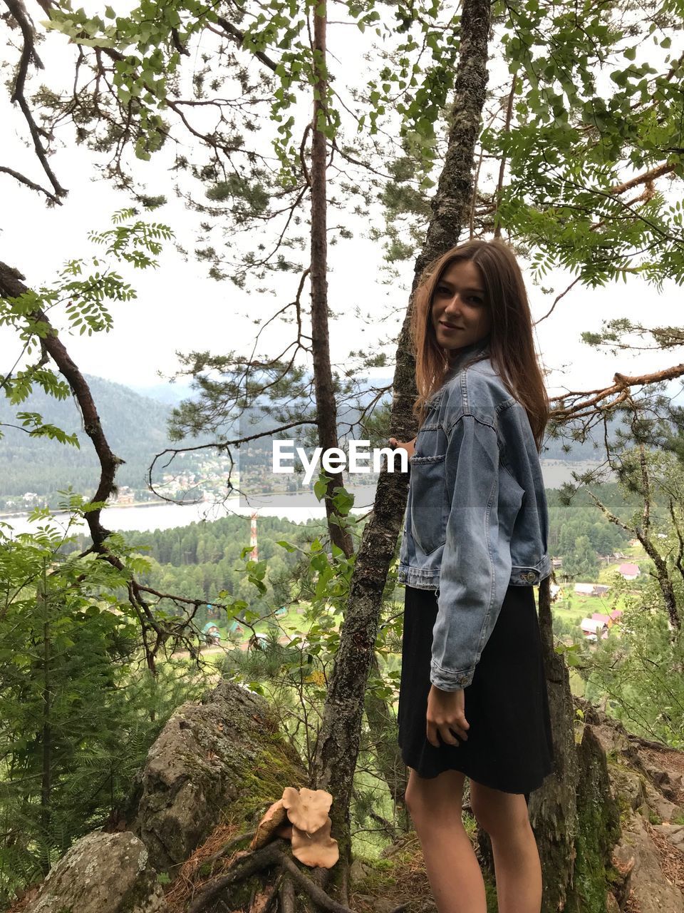 Portrait of woman standing in forest