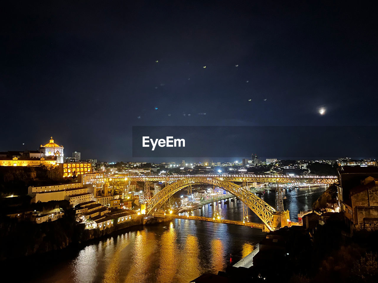 high angle view of illuminated bridge over river at night