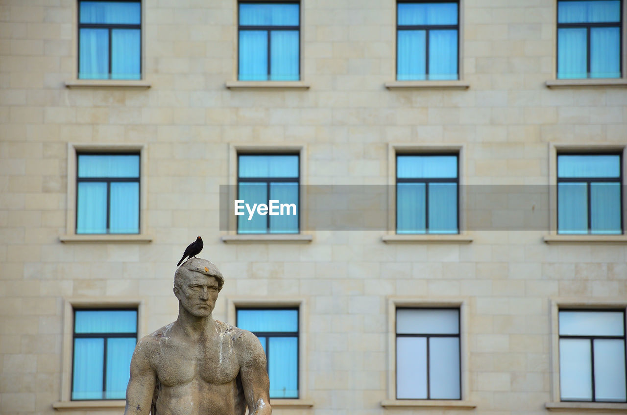 Low angle view of statue against building