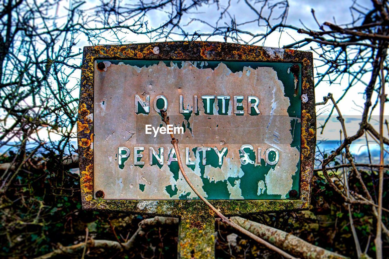 LOW ANGLE VIEW OF TEXT ON RUSTY METAL