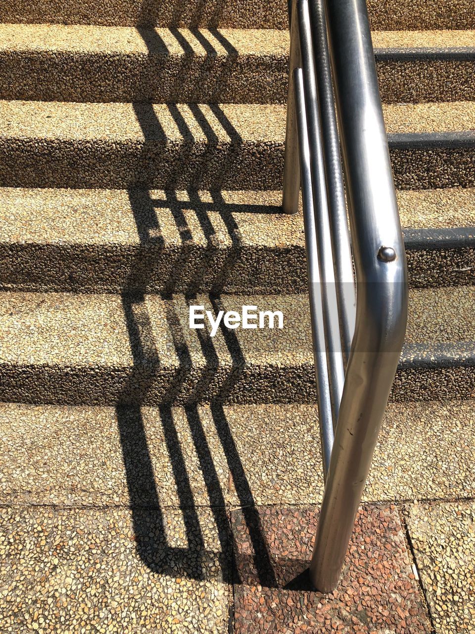 HIGH ANGLE VIEW OF SHADOW ON METAL