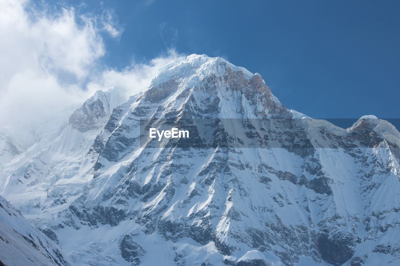 Scenic view of mountains against cloudy sky