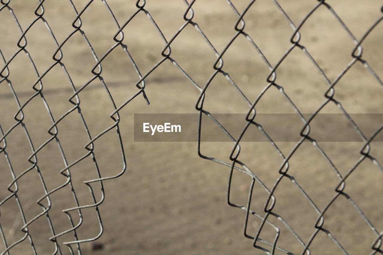 Chainlink fence seen through chainlink fence