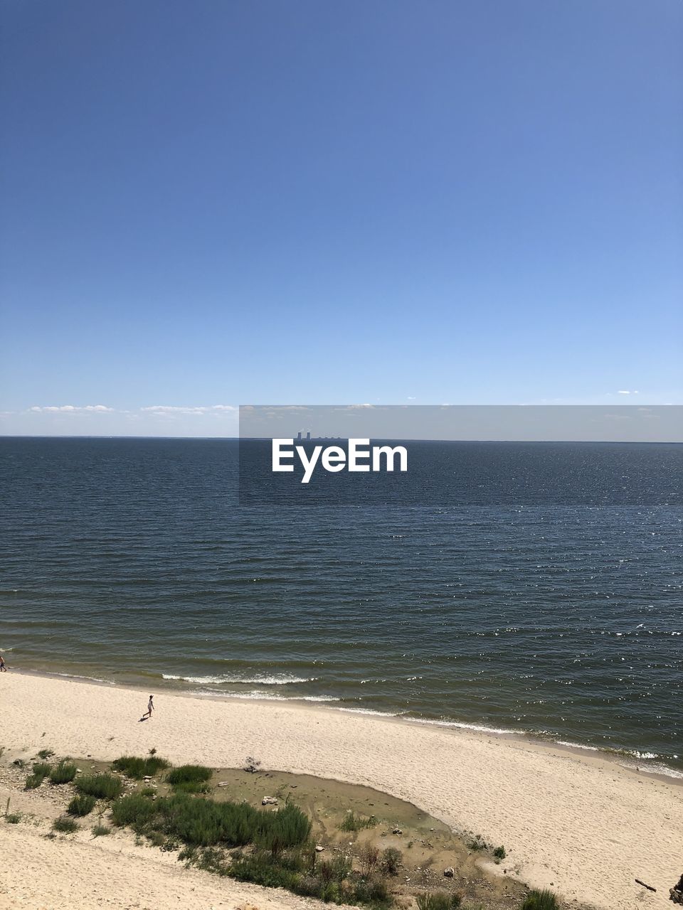 Scenic view of sea against clear blue sky