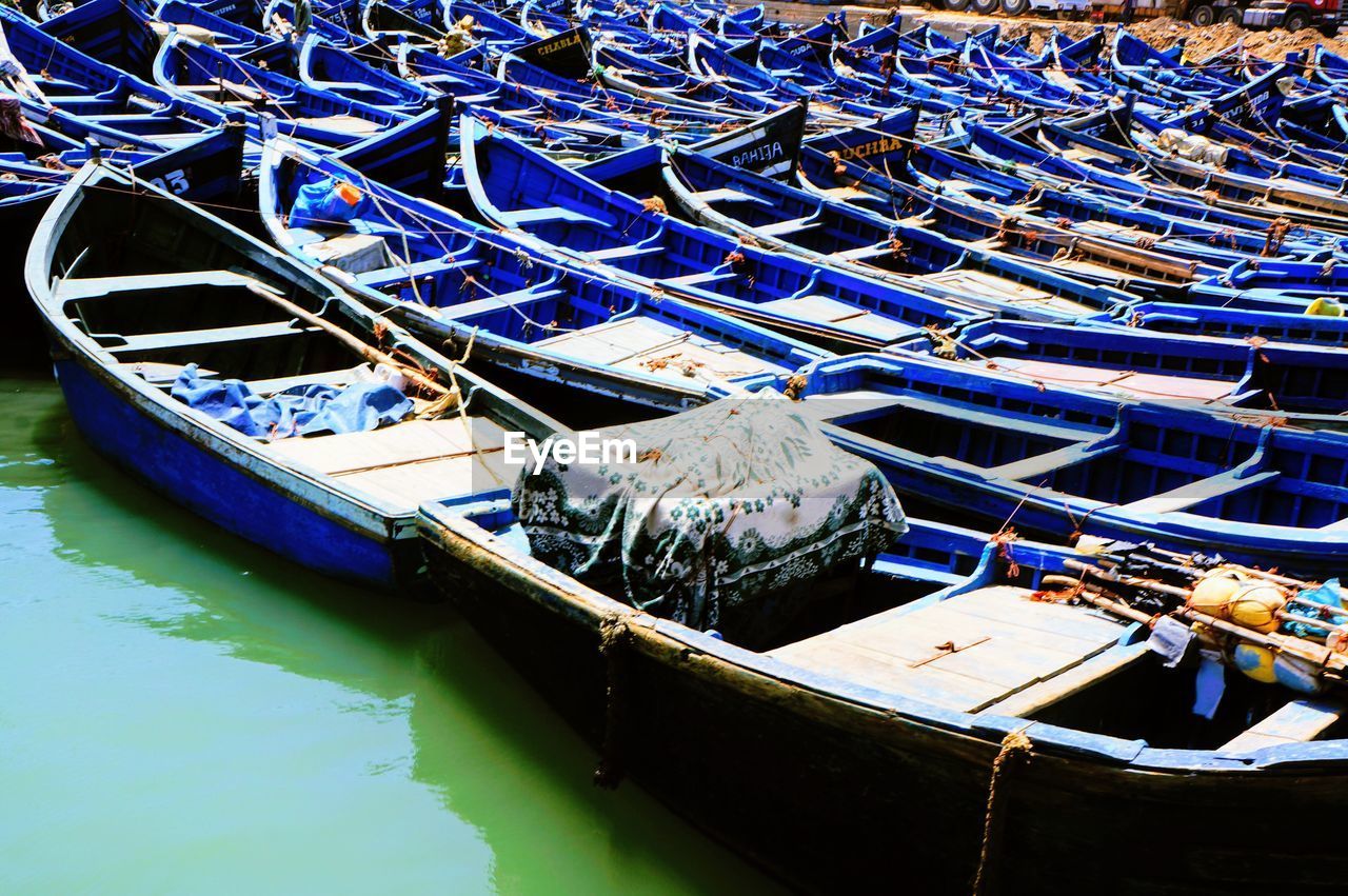 HIGH ANGLE VIEW OF FISHING BOATS MOORED IN HARBOR