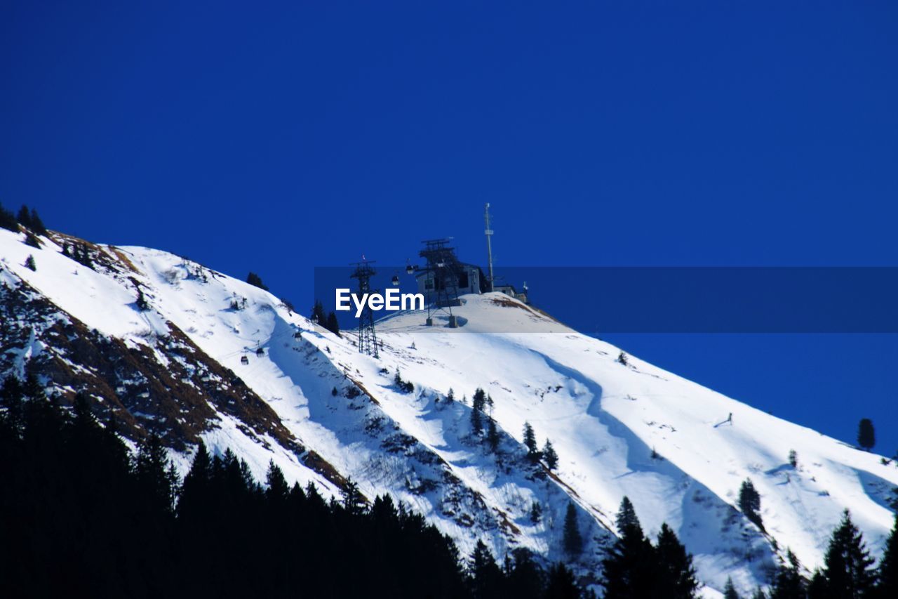 SNOWCAPPED MOUNTAINS AGAINST CLEAR BLUE SKY