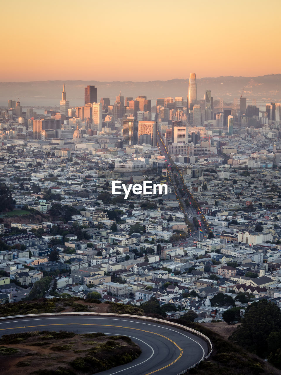 Aerial view of cityscape against sky during sunset