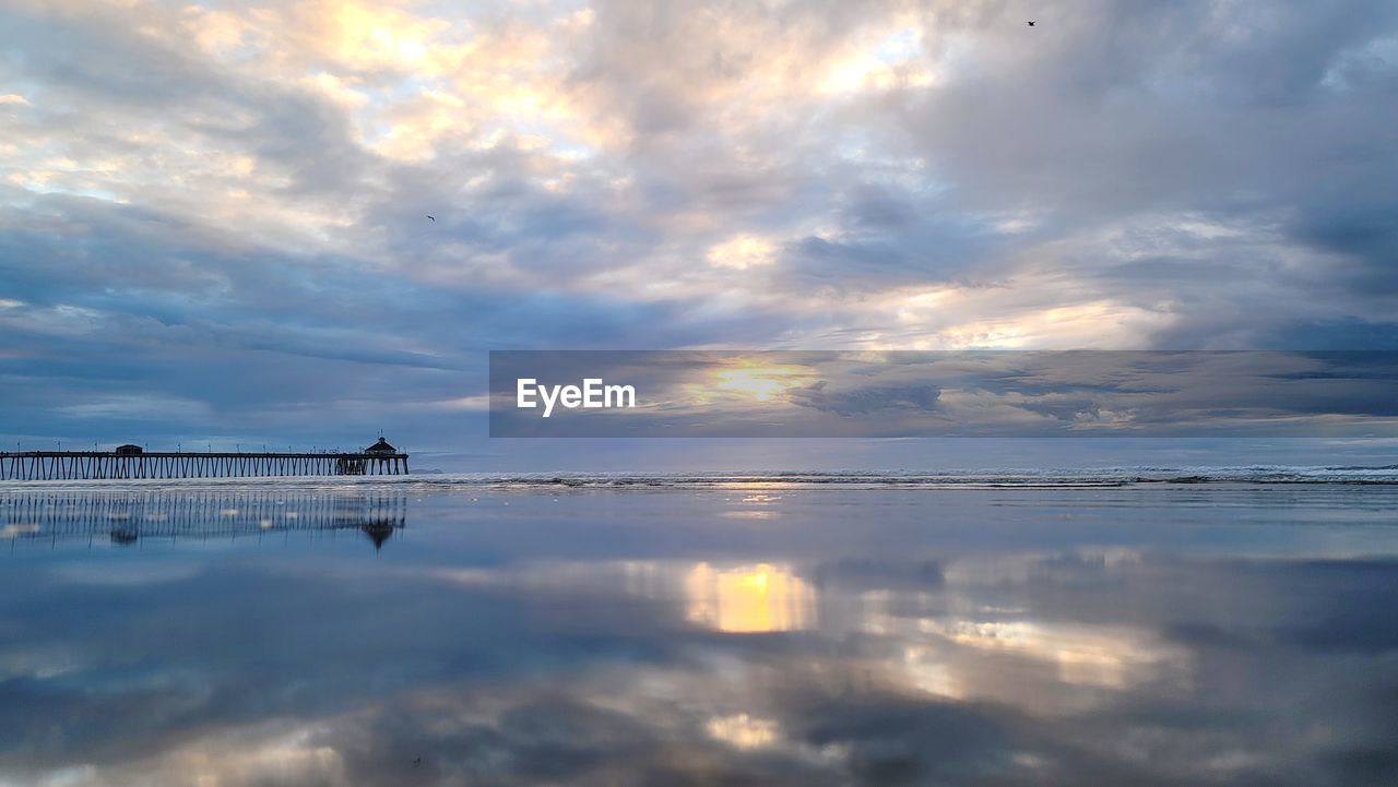 water, sky, cloud, reflection, beauty in nature, sea, scenics - nature, nature, morning, horizon, tranquility, dawn, environment, sunlight, sunrise, tranquil scene, shore, landscape, dramatic sky, travel, outdoors, horizon over water, ocean, blue, beach, land, sun, travel destinations, cloudscape, idyllic, no people, wave, seascape, trip, coast, vacation, holiday, tourism, nautical vessel, lagoon, silhouette