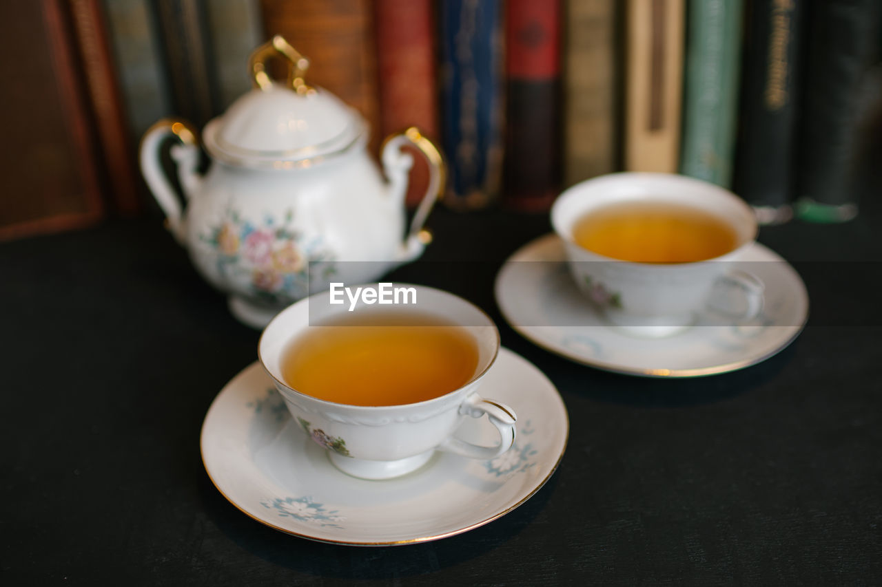 tea, cup, tea cup, hot drink, mug, drink, food and drink, teapot, crockery, refreshment, afternoon tea, saucer, porcelain, ceramic, table, da hong pao, indoors, no people, food, close-up, still life, focus on foreground, coffee cup, oolong, tradition, high angle view, kitchen utensil, freshness