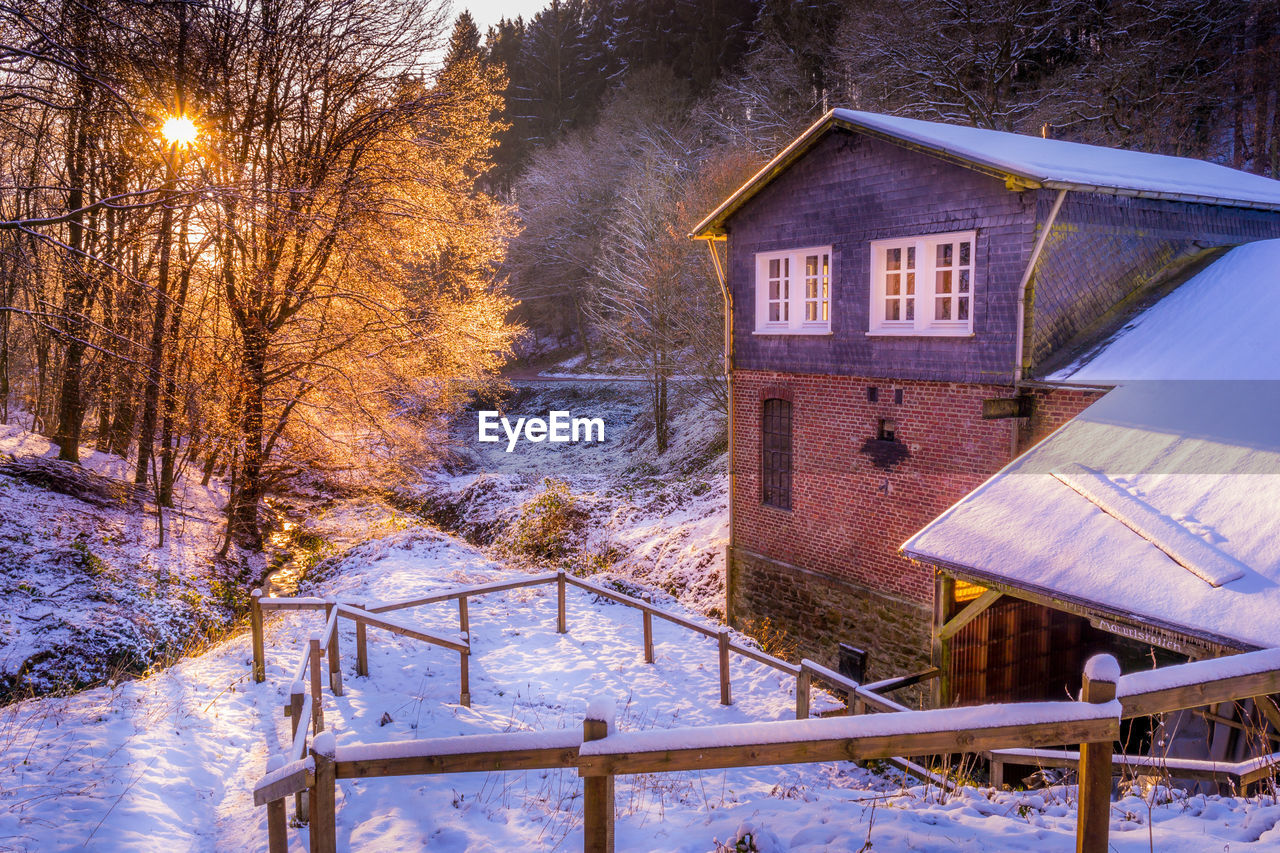 House on snow covered landscape during winter